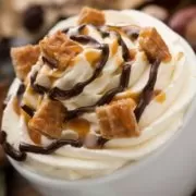 A whipped cream topped with caramel and nuts.