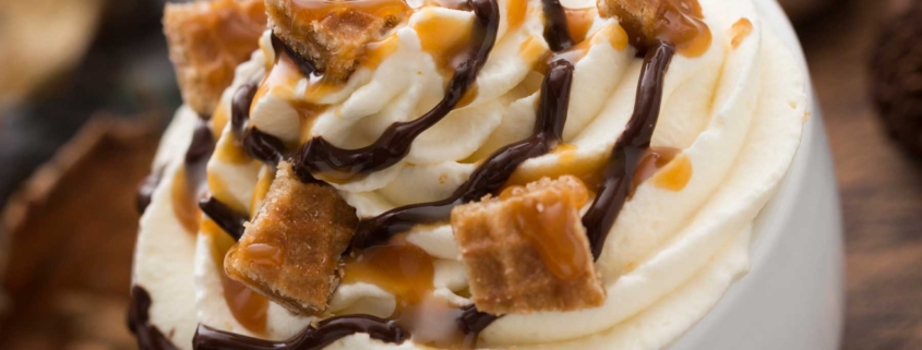 A whipped cream topped with caramel and nuts.