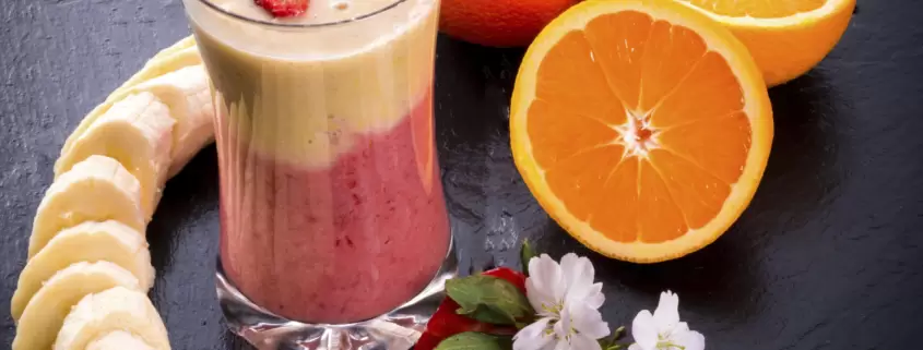A smoothie with oranges and bananas.