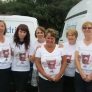 Walk for Dreams A group of women standing in front of a van.
