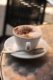 A cup of coffee on a table.