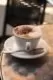 A cup of coffee on a table.