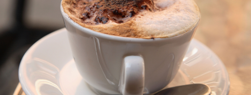 A cup of coffee on a table.