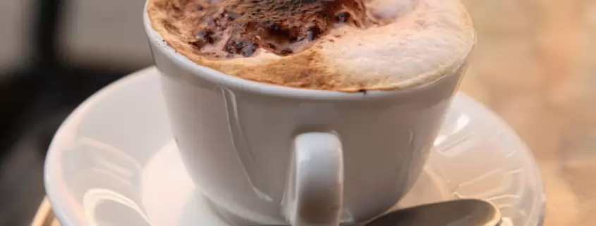 A cup of coffee on a table.