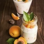 Apricot breakfast Two jars of yogurt with apricots in them.