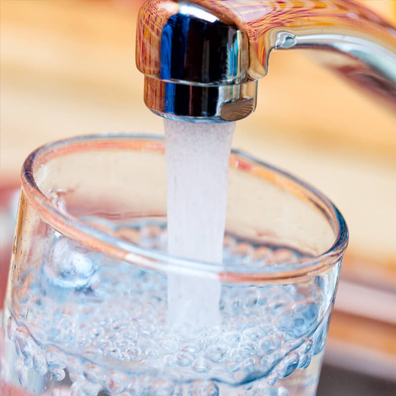 tap-filling-water A glass of water is being poured into a sink using Taps.