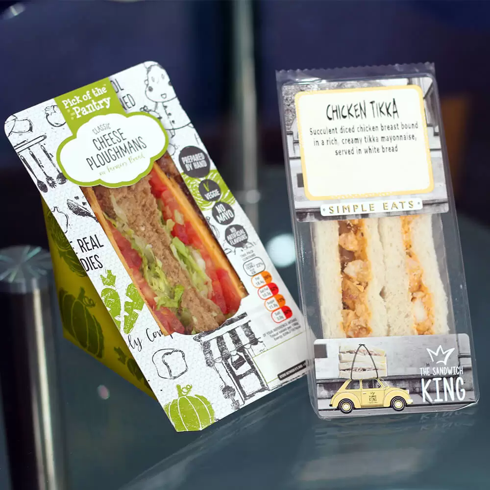 A fresh sandwich is sitting on a table next to a car.