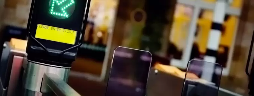A group of people doing squats in front of a ticket machine.