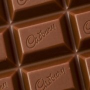 A close up of a chocolate bar with the word Cadbury written on it, reminiscent of the 'drumming gorilla' TV commercial.