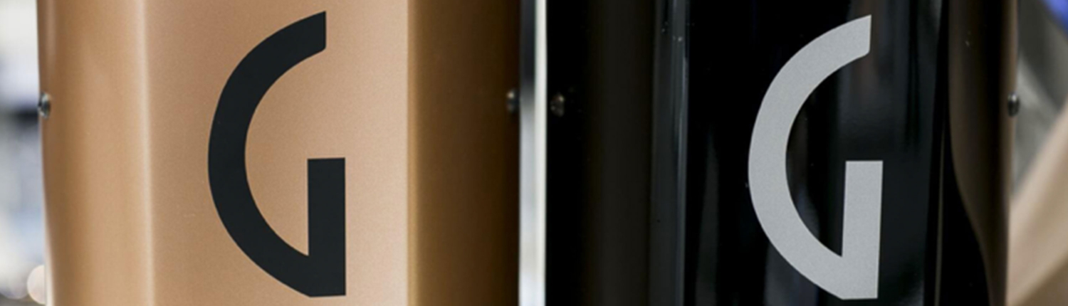 Two bicycles with the letter G on them, one of which is a Gaggia.