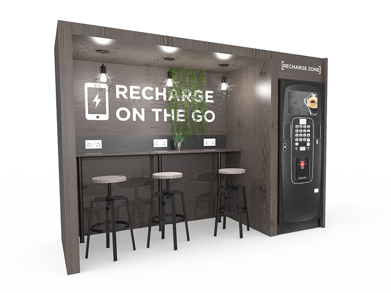 A booth with a bar and a machine that says recharge on the go.