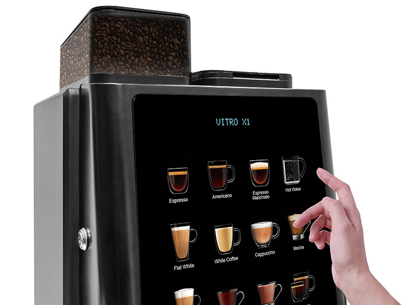 x1_accesories A person is pointing at a Vitro X1 coffee machine.