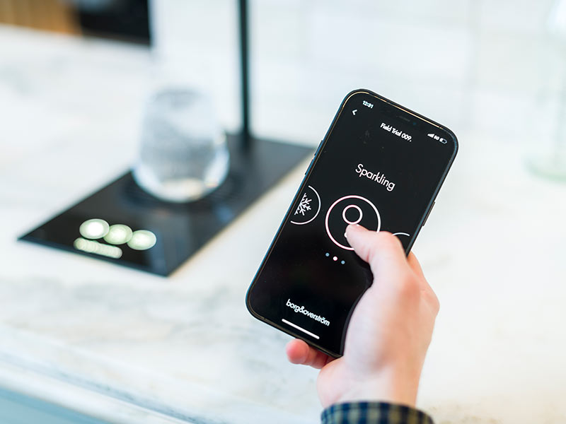 Contactless A person holding a smart phone with a button on it.