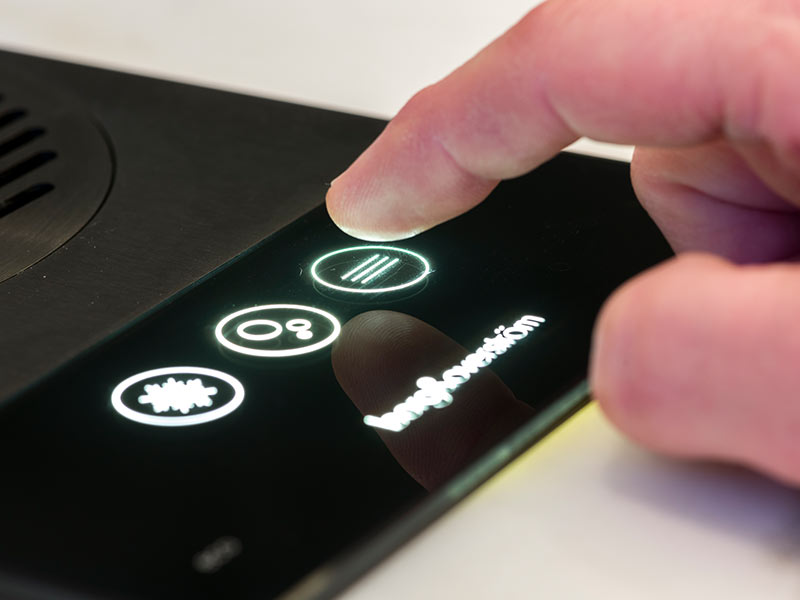 Hygiene A person pressing a button on a black phone.