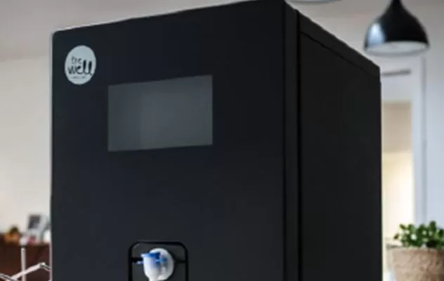 A black coffee machine sitting on top of a table.