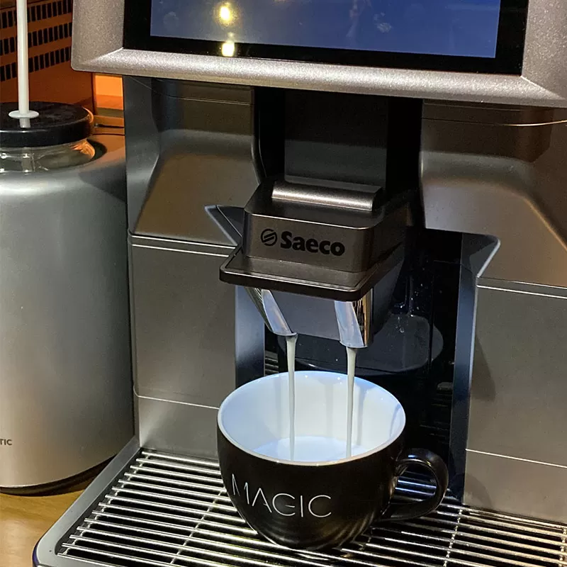 A coffee machine is being used to make coffee.