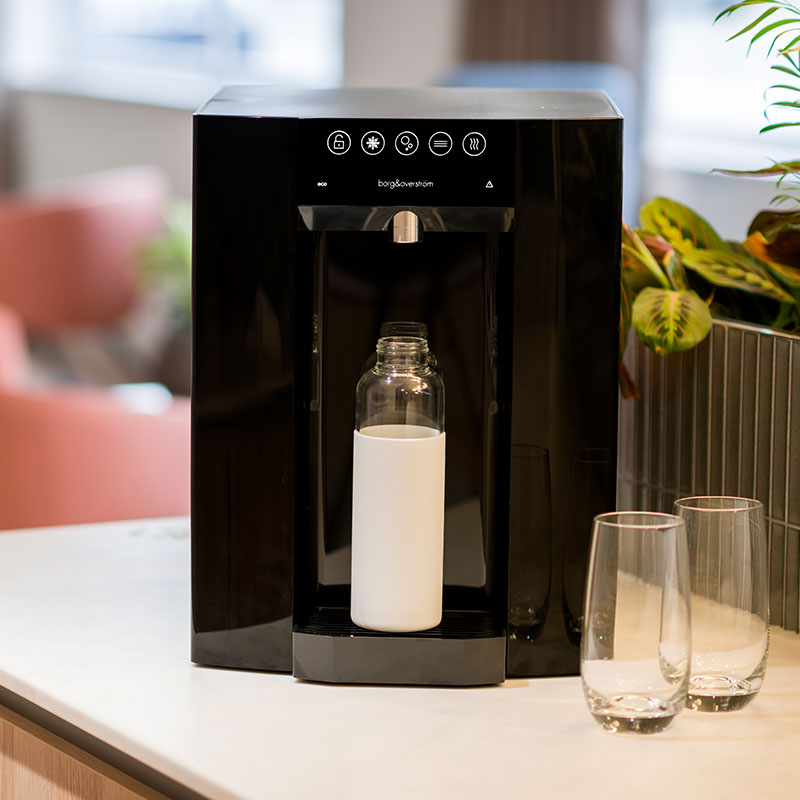 Borg-Story-3 A bottle of water is sitting on a table next to a water dispenser.