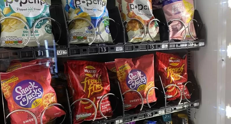 A vending machine filled with chips and snacks.