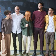 workplace-wellbeing A group of people standing in front of a chalkboard.