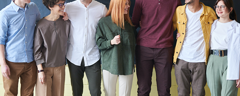 A group of people standing in front of a chalkboard.