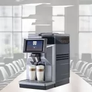 Magic M2+ tabletop coffee machine superimposed over a boardroom table.