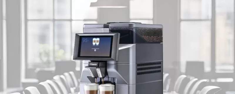 Magic M2+ tabletop coffee machine superimposed over a boardroom table.