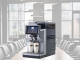 Magic M2+ tabletop coffee machine superimposed over a boardroom table.