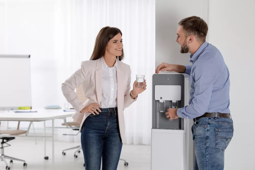 Employees having a break around the water cooler