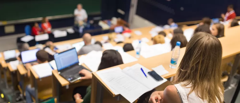 Student in a lecture hall class with a bottle of water
