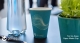A Go-Aqua 7oz paper water cup on an office table.