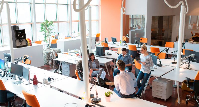 Staff enjoying a coffee break with the Vitro office coffee machine in the background.